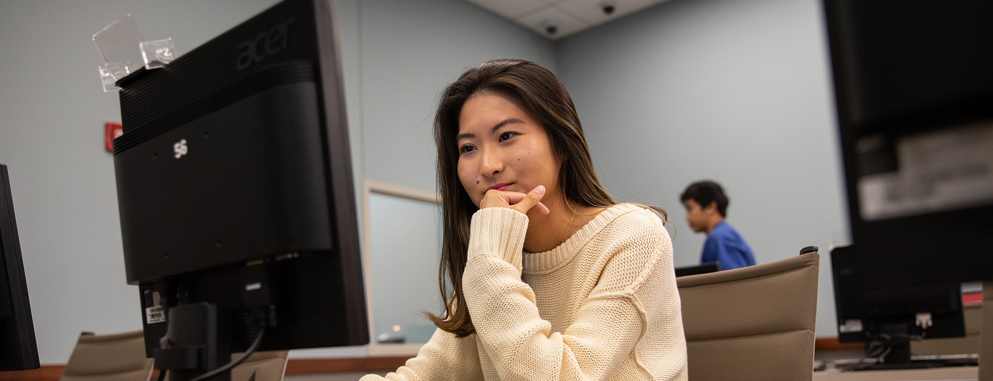 Texas Tech student in a classroom looking at a computer screen