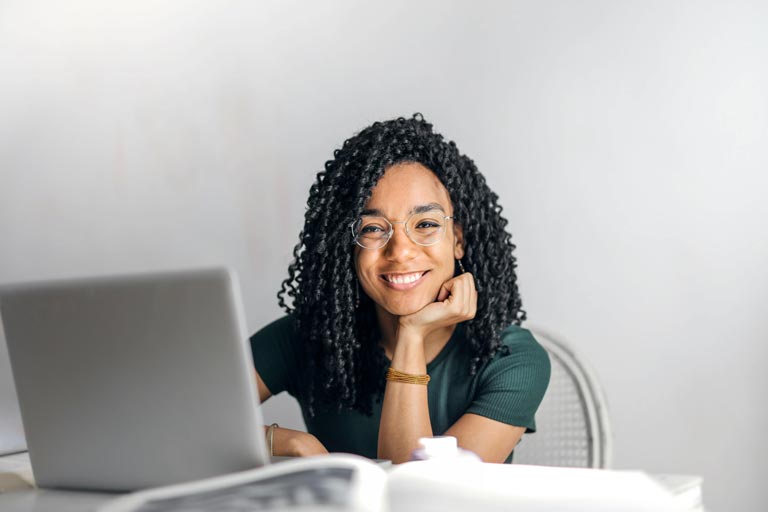 Student smile at their computer