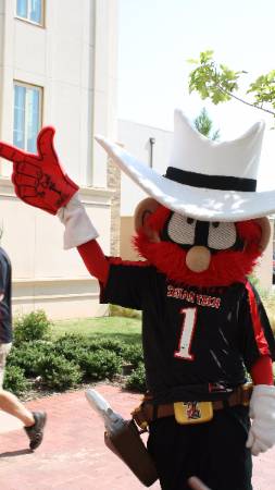 Raider Red mascot pointing a foam finger on Texas Tech campus