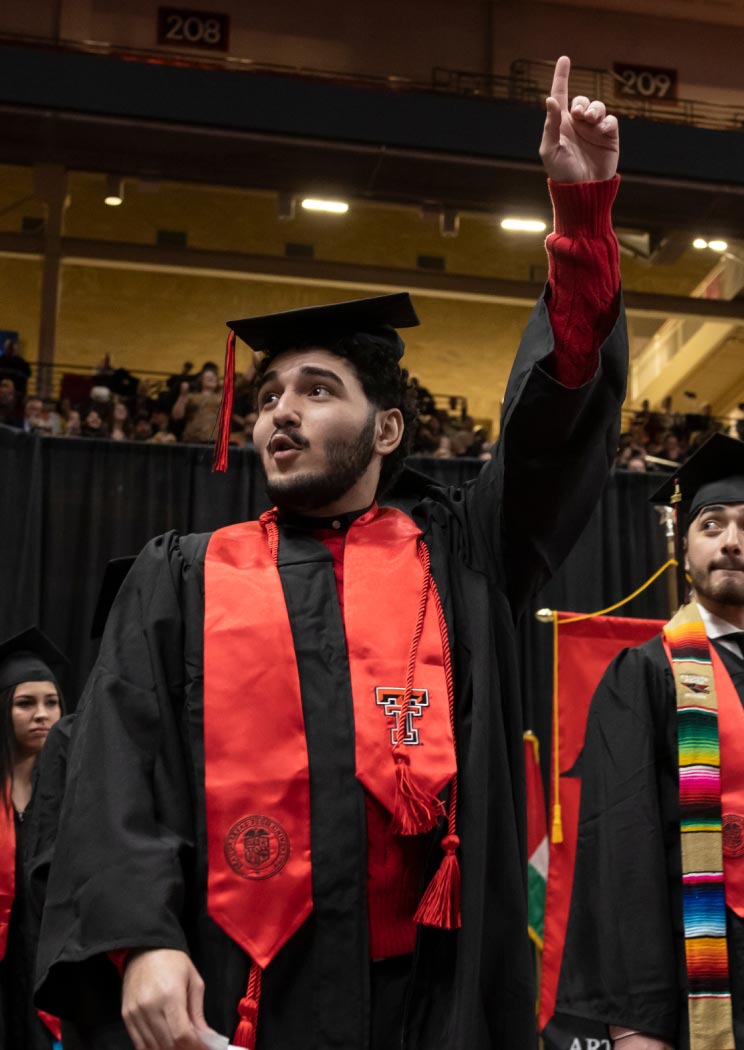 texas tech student graduating with cap and gown and guns up emote