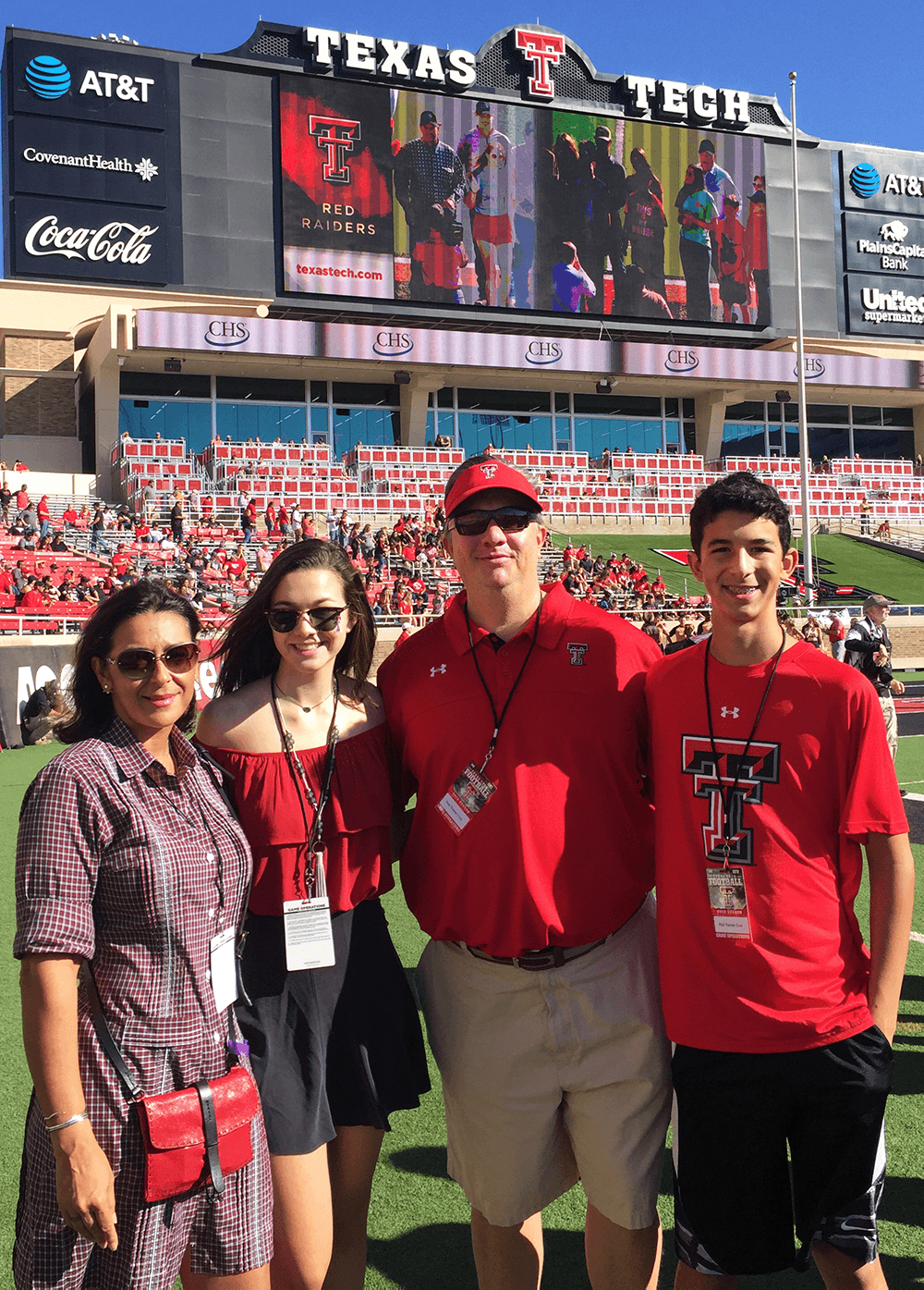 TTU alumni Cecilia and Jim Edwards with their children at a Texas Tech football game