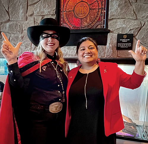 TTU staffer Raquel Gonzales, at right, with the Masked Rider