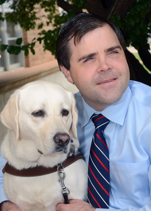 TTU professor Adam Schmidt, at right, with service dog