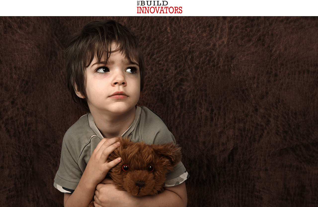 image of frighten child holding a teddy bear