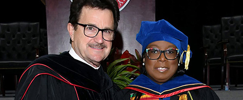 Dr. O.W. Petcoff and President Lawrence Schovanec shaking hands