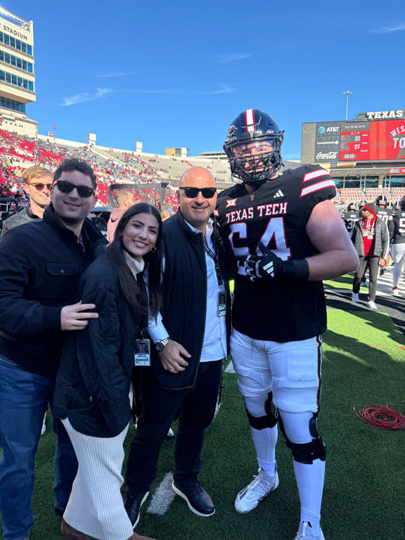 Dr. Al-Hmoud and family posing with Jurrien on the field
