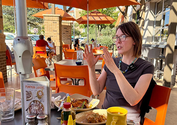 Jen Henderson sitting at a restaurant table 