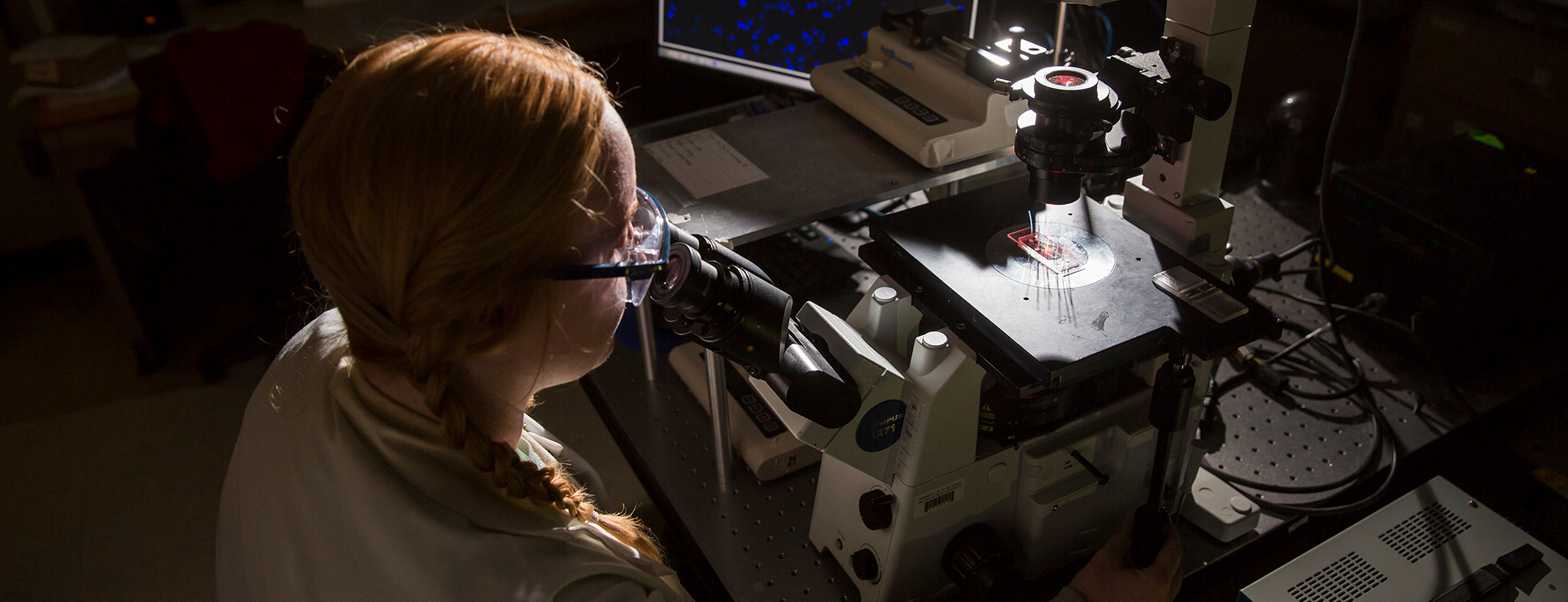 phd student using a microscope