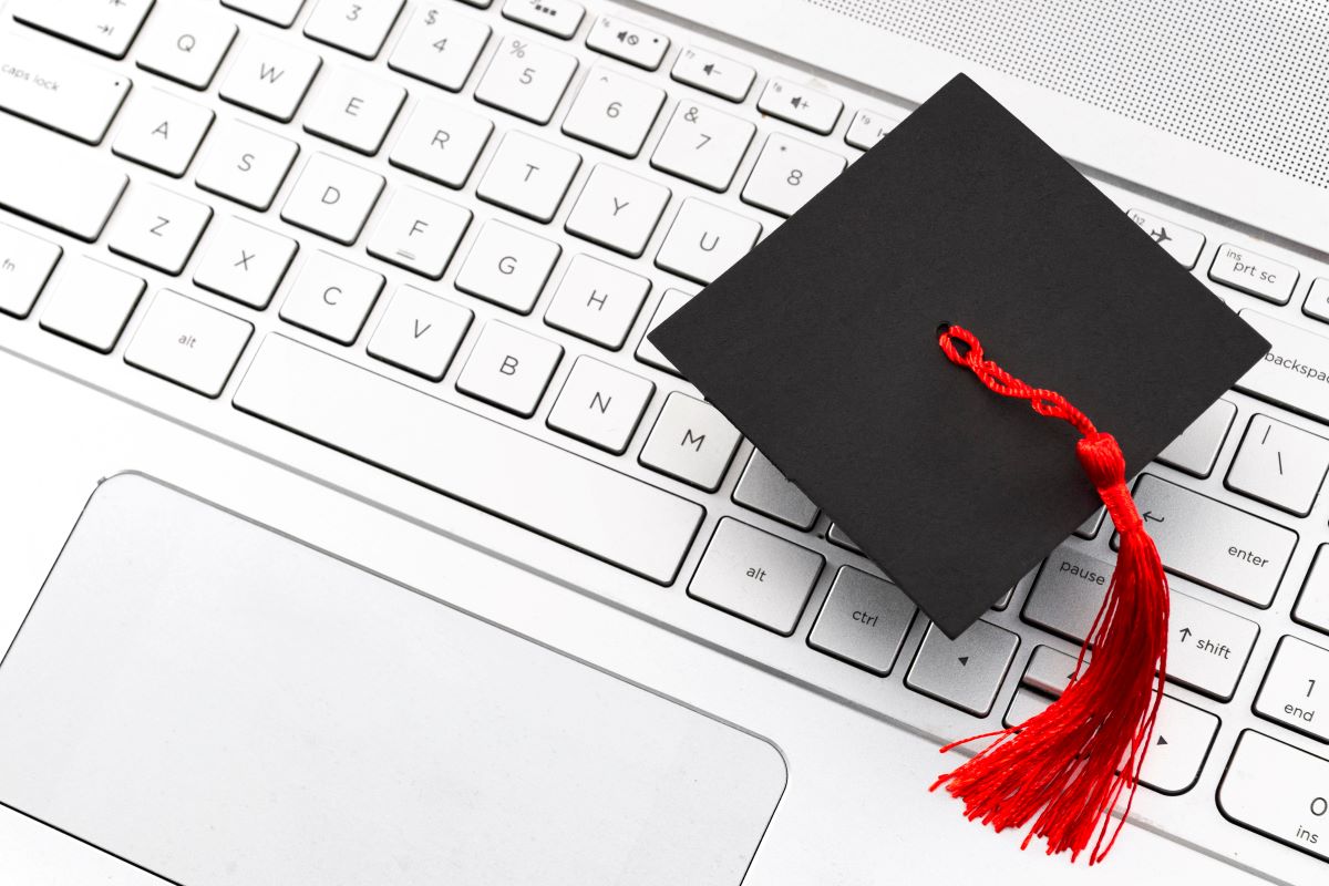 Red and Black Graduation Cap on Laptop Red and Black Graduation Cap on Laptop
