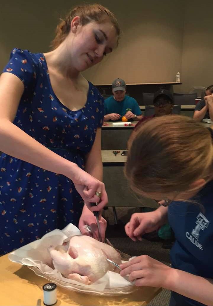 TriBeta Suture Clinic - Students learning sutures on raw chicken