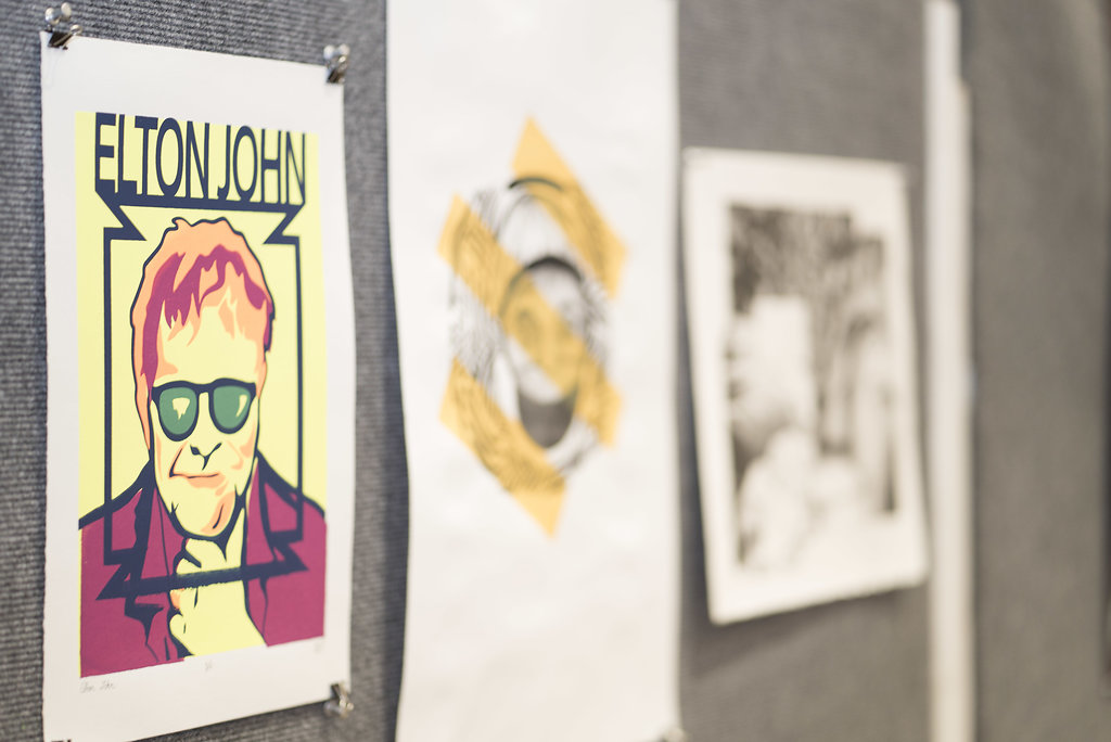 display of three art pieces on a panel
