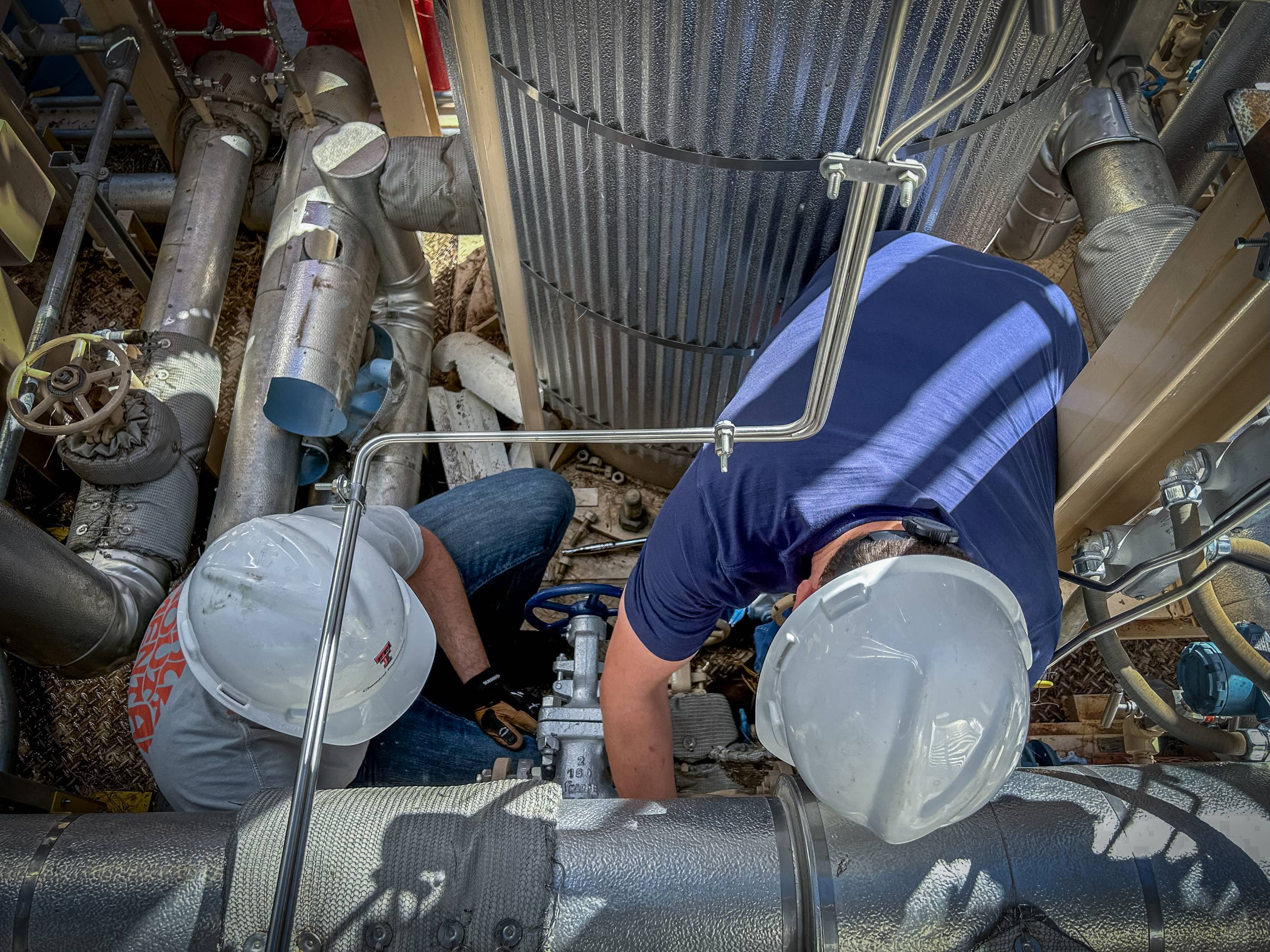 Students working together to replace a pump component.