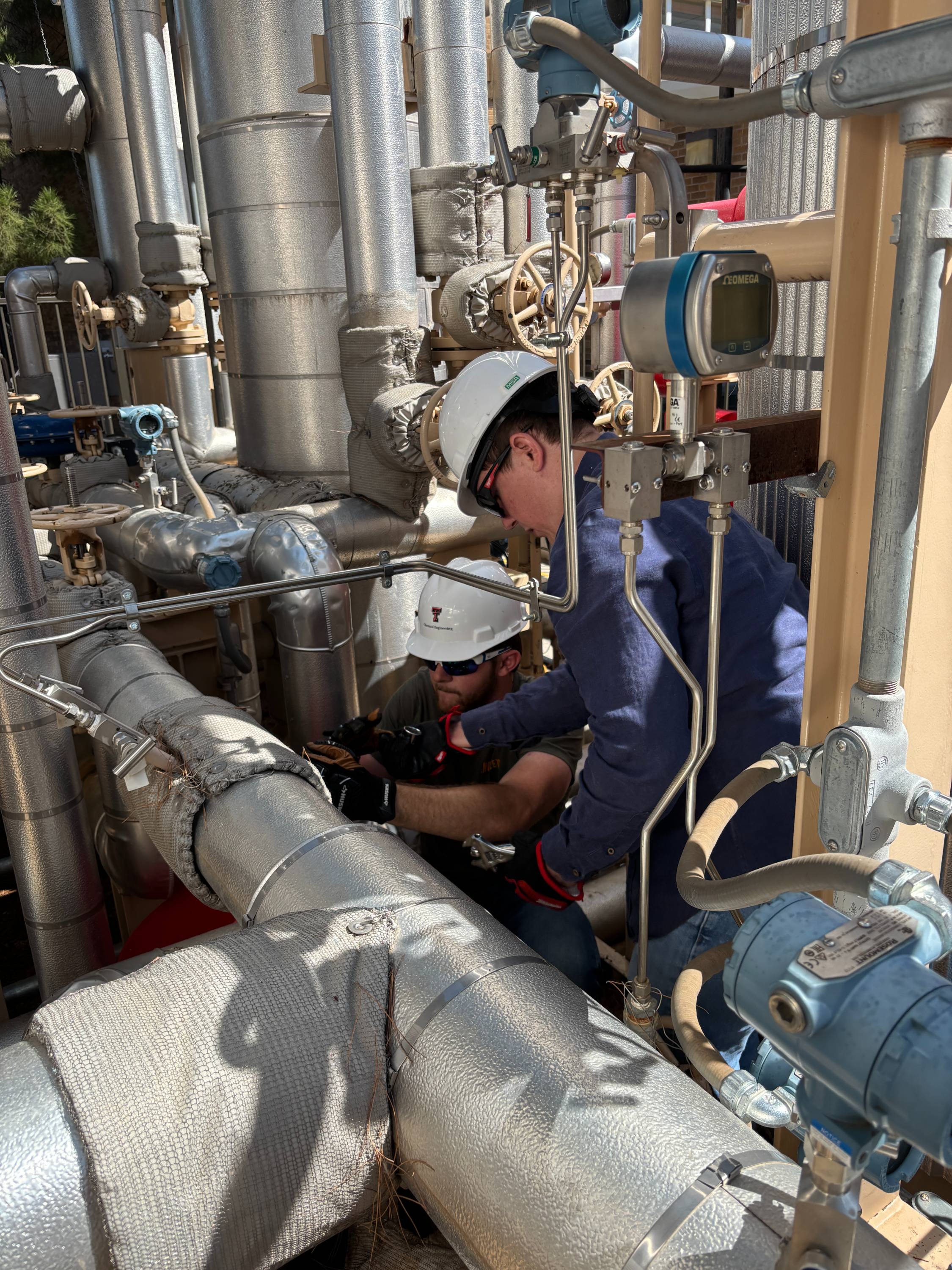 Students working together to replace a pump component.