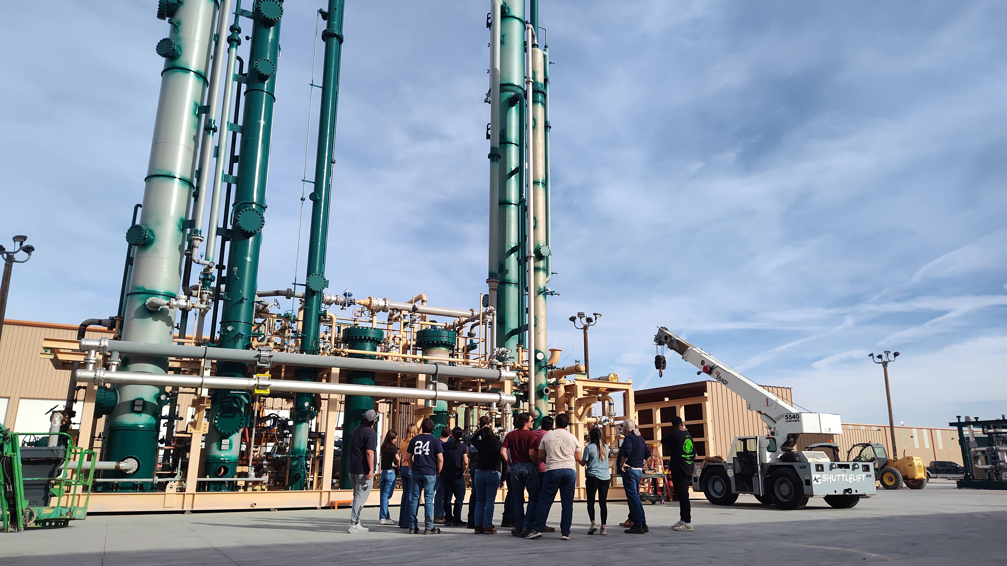 Students working together to replace a pump component.