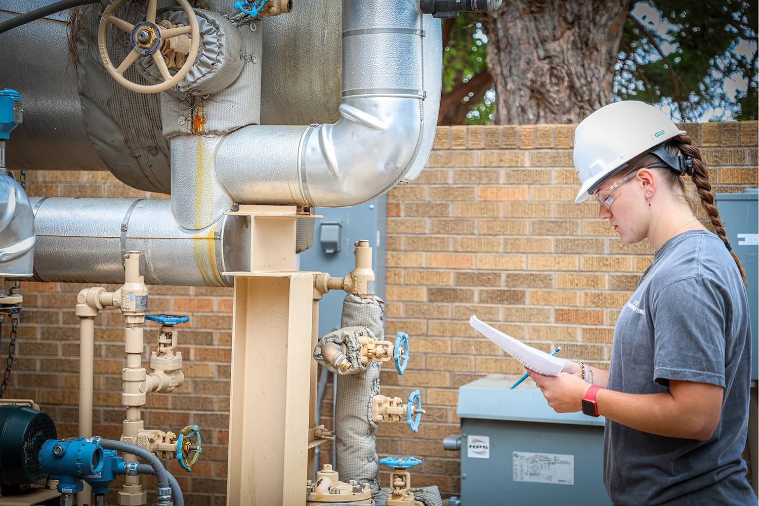 Students working together to replace a pump component.