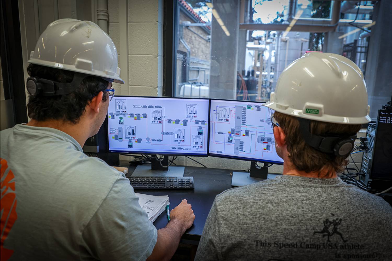 Students working together to replace a pump component.