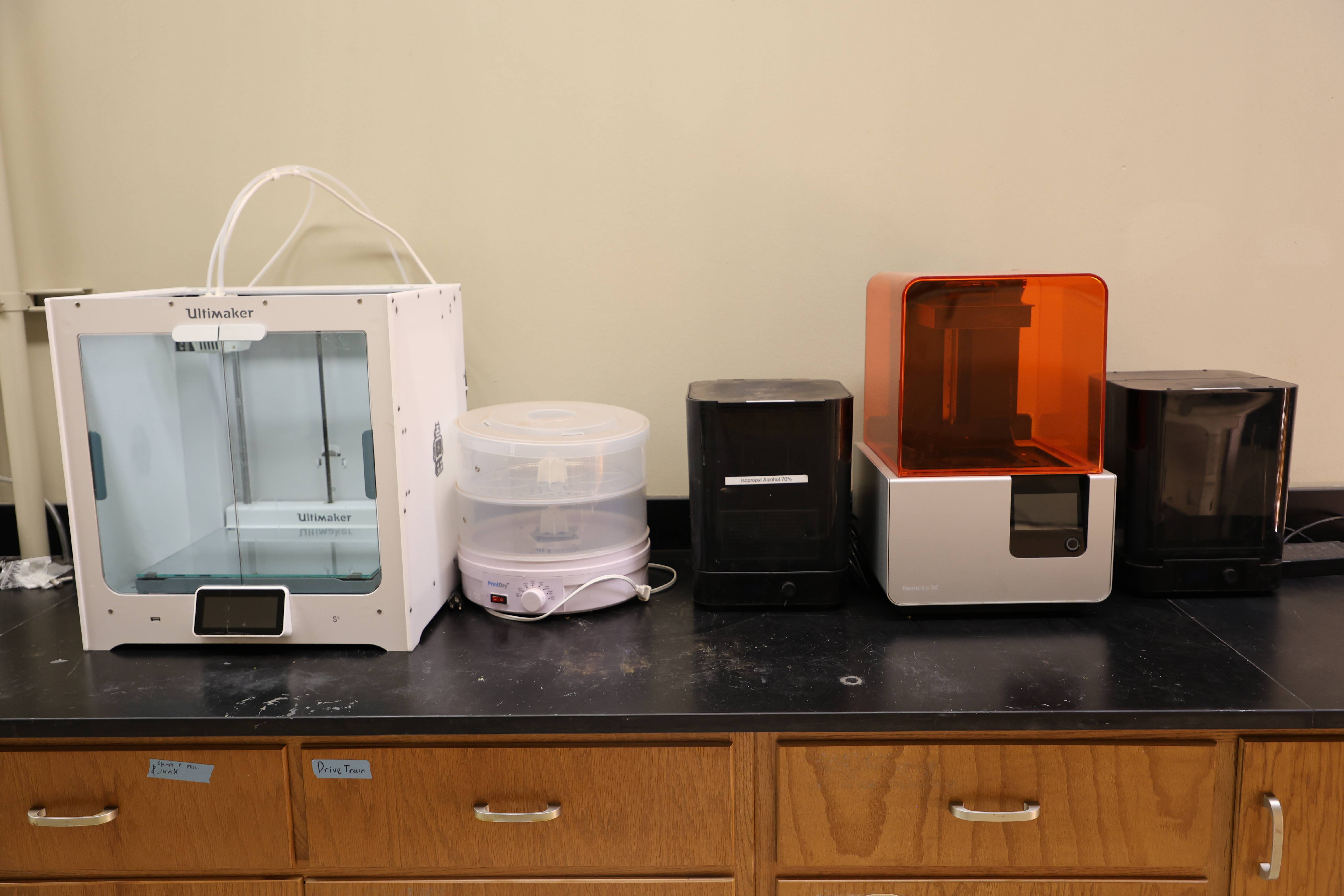 Students inspecting piping and valves inside the pilot plant.