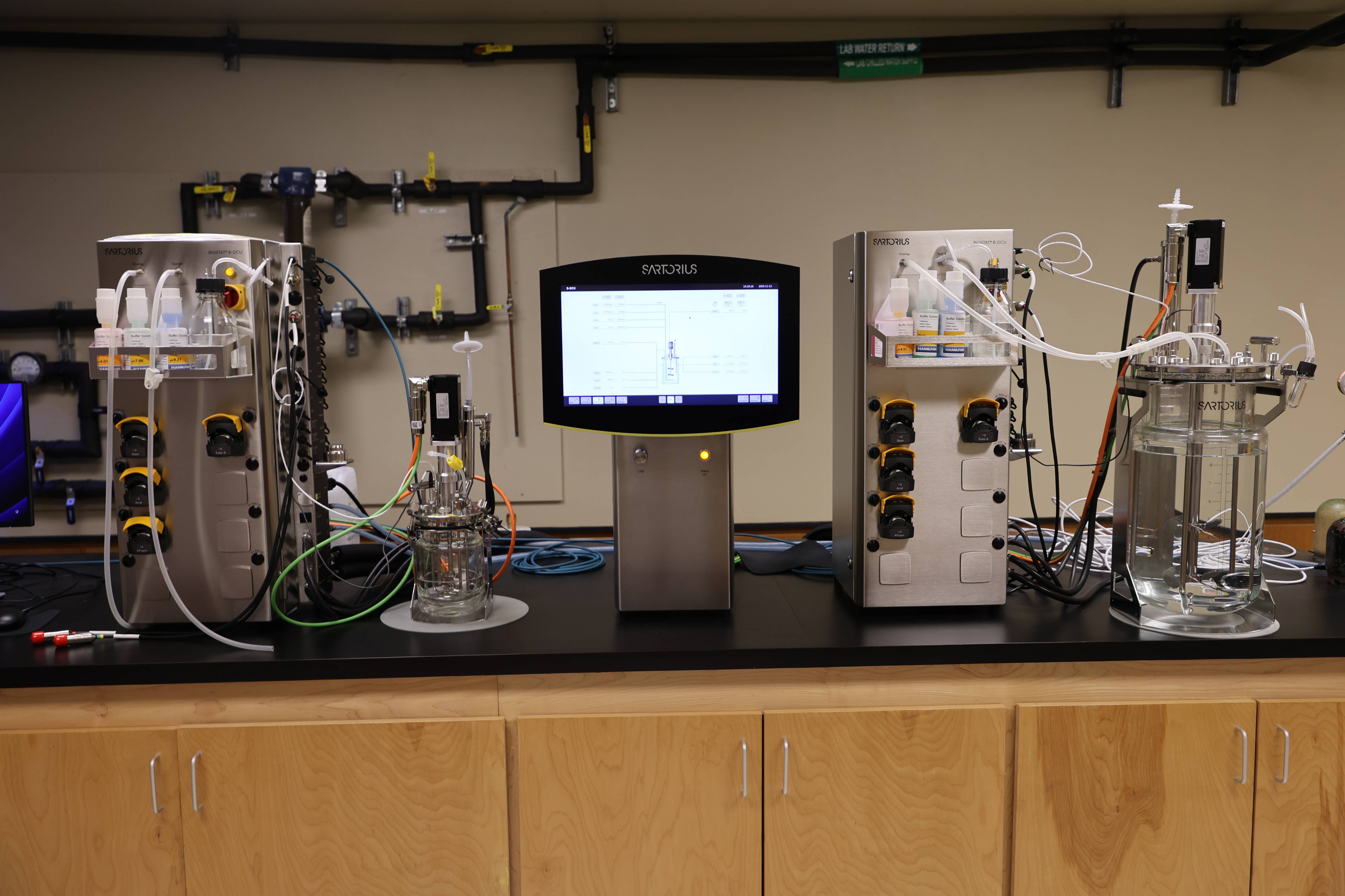 Student adjusting a control panel while monitoring readings.