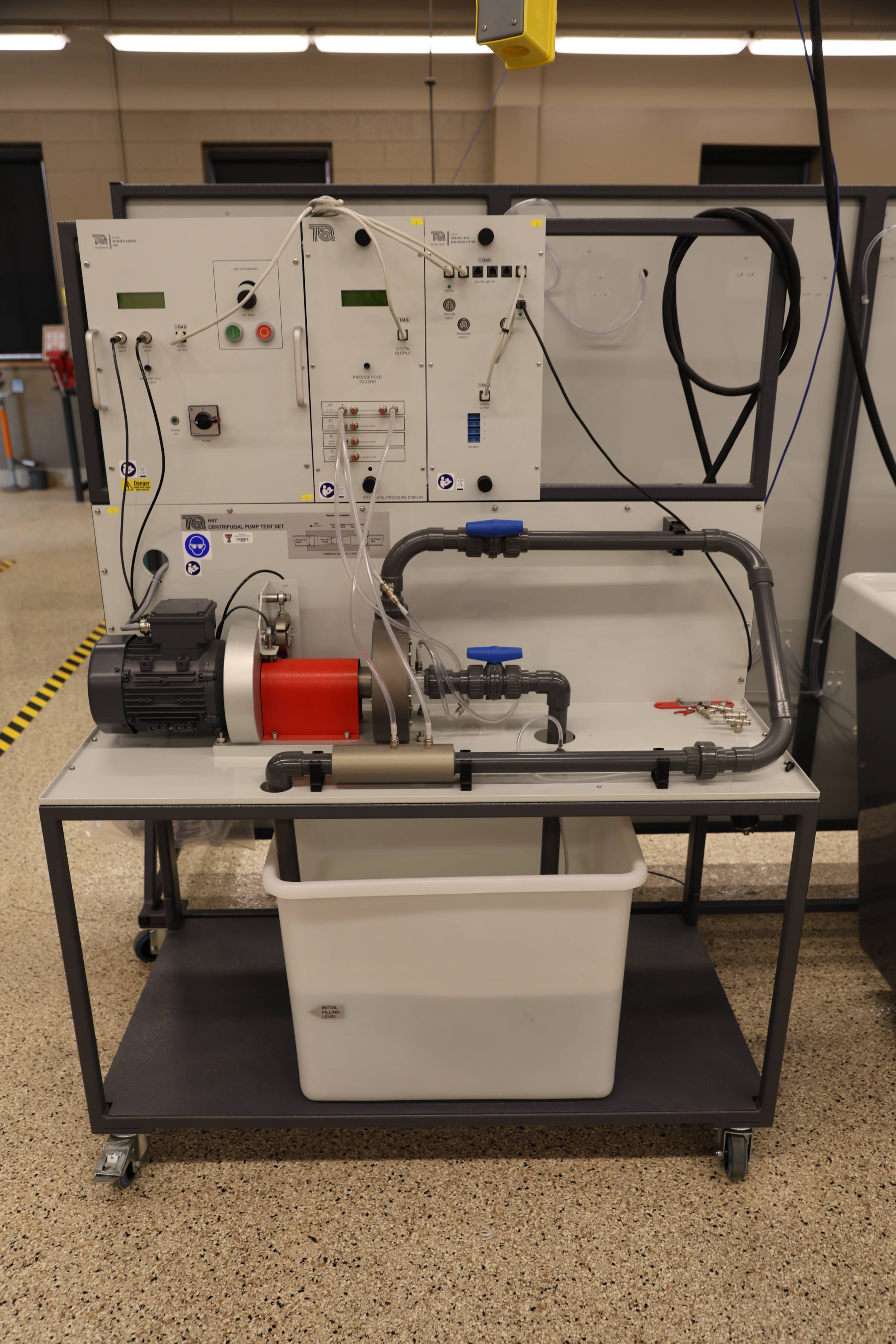 Students working together to replace a pump component.