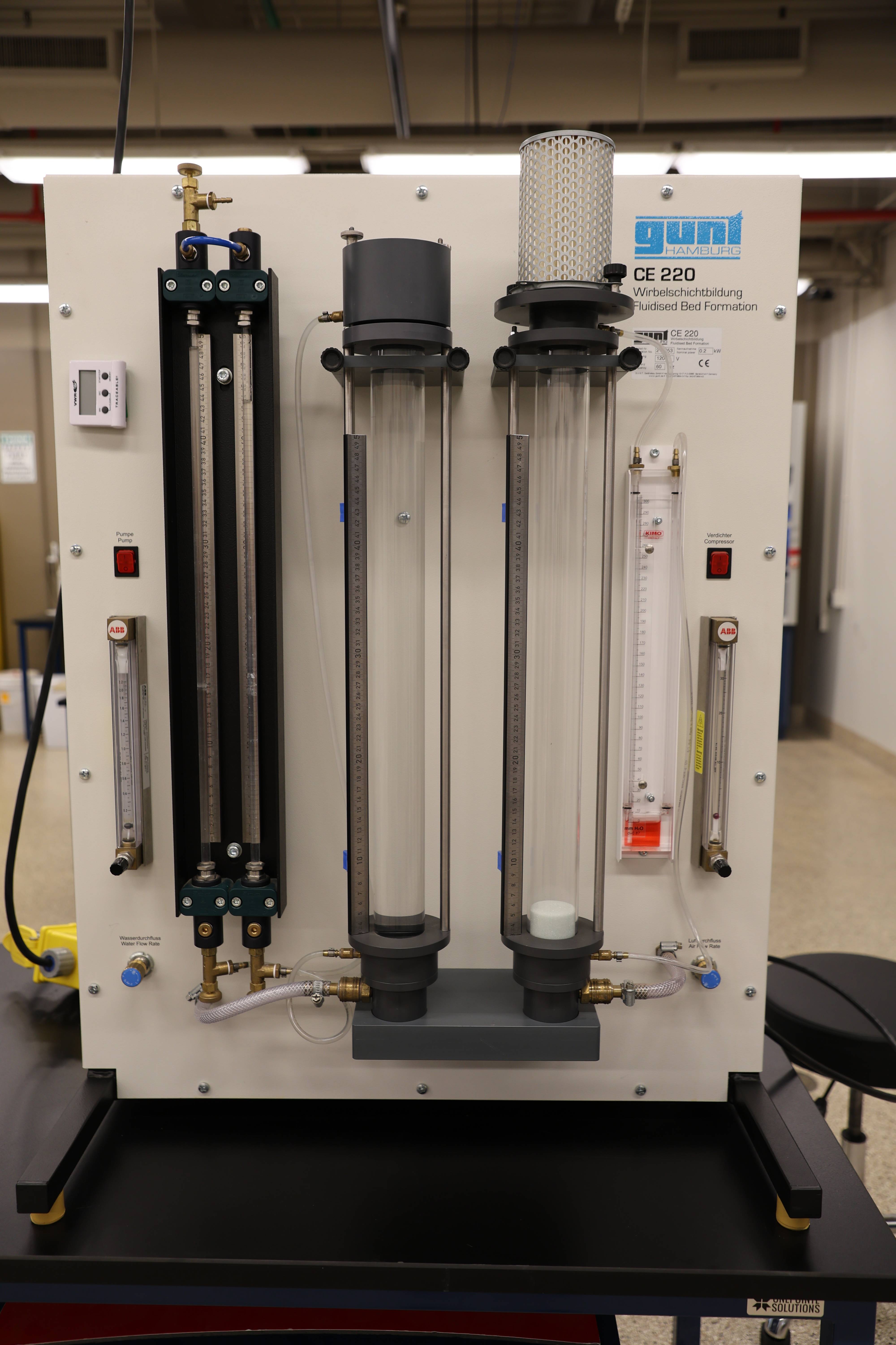 Students working together to replace a pump component.