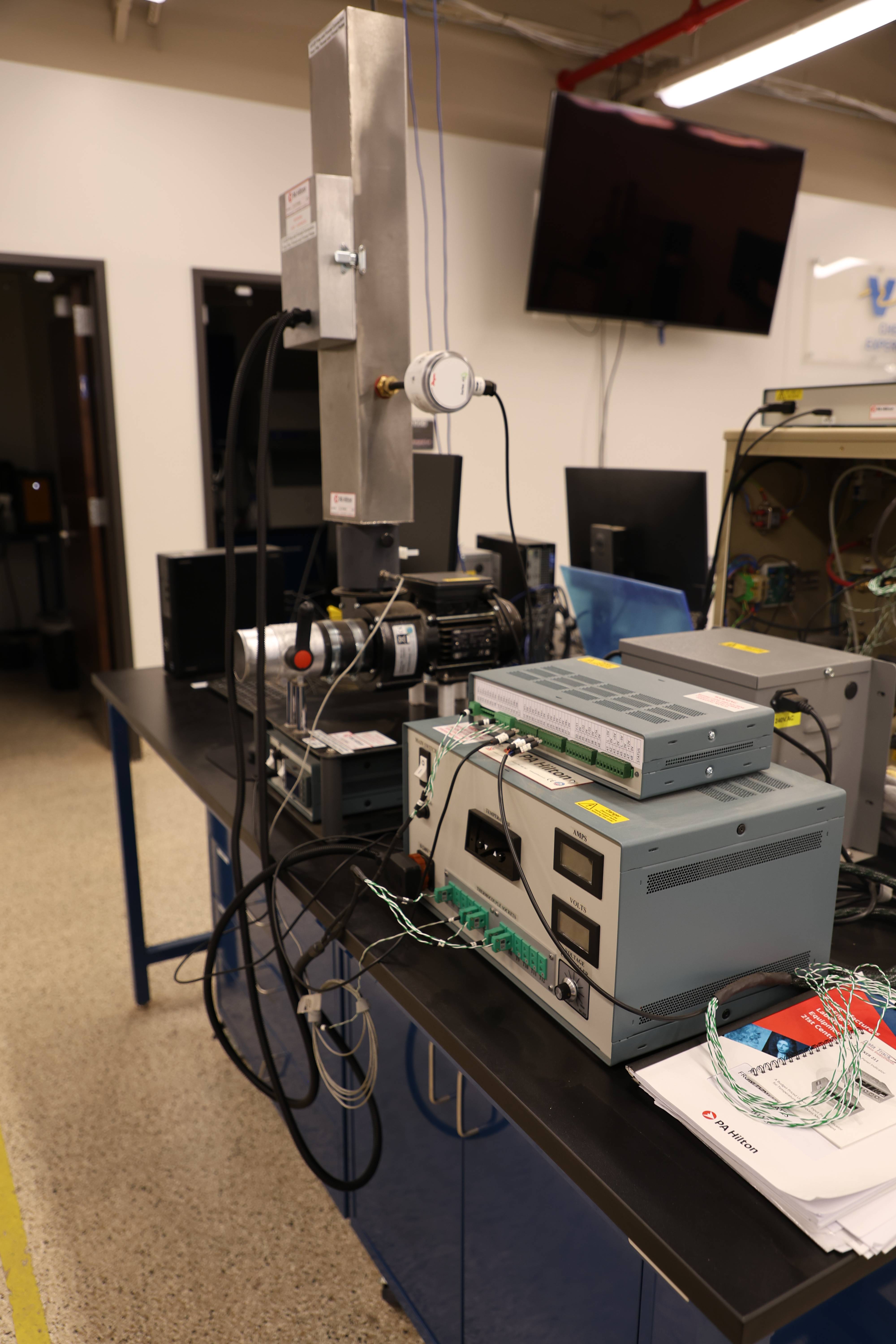 Students working together to replace a pump component.