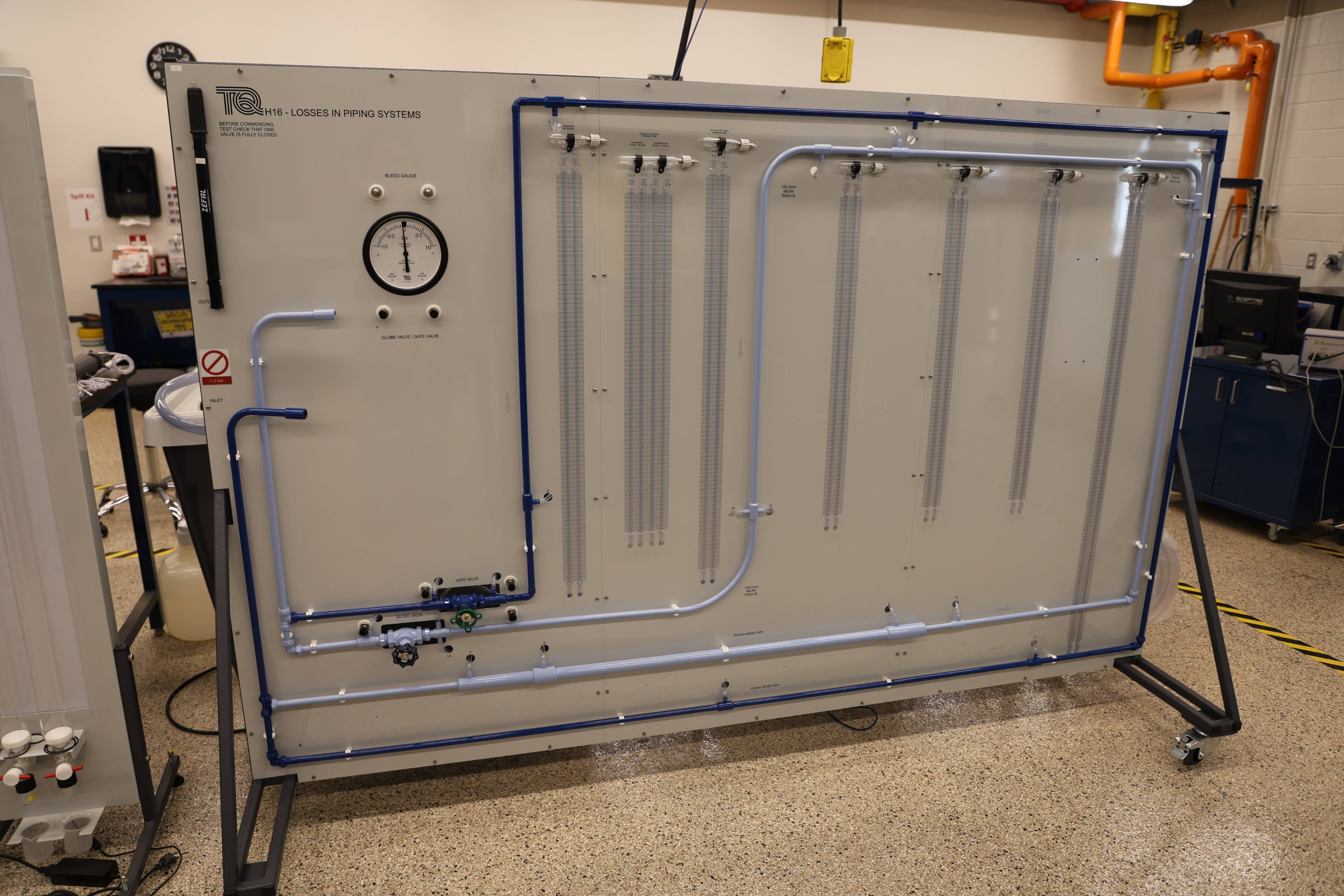 Students working together to replace a pump component.