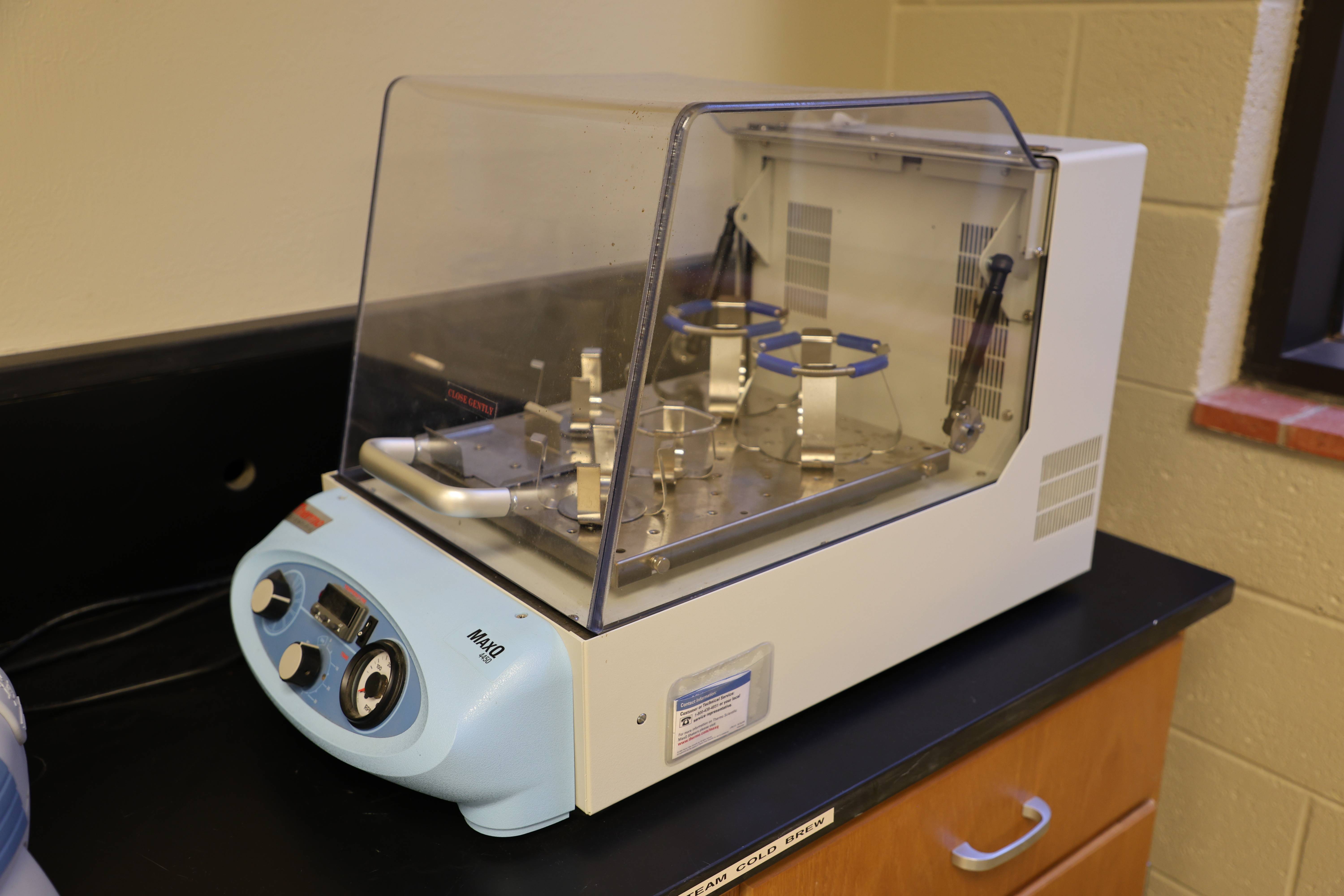 Students working together to replace a pump component.