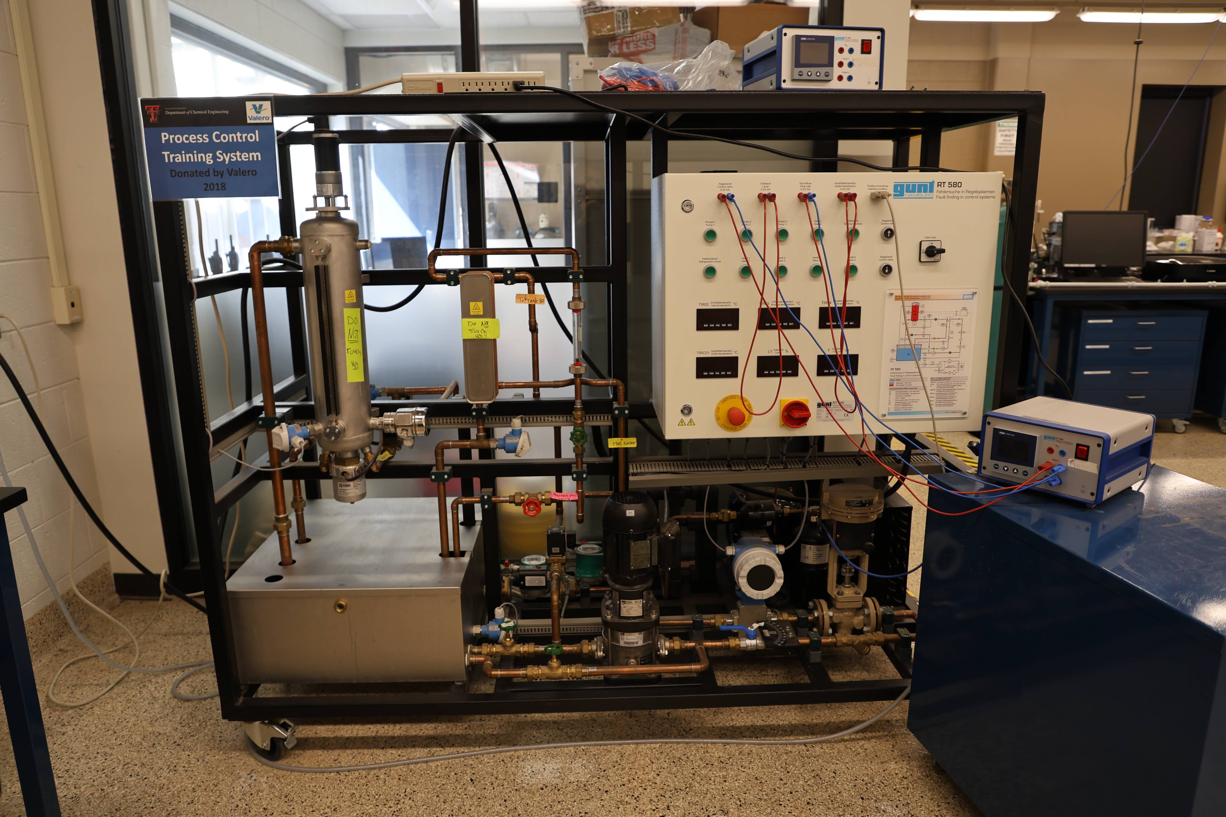 Students working together to replace a pump component.