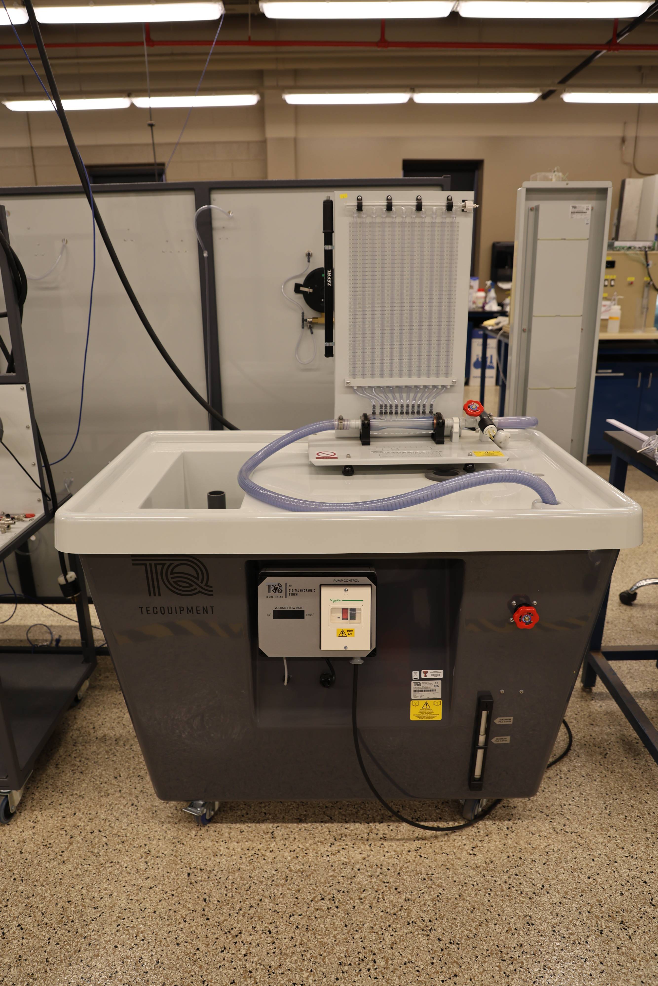 Students working together to replace a pump component.