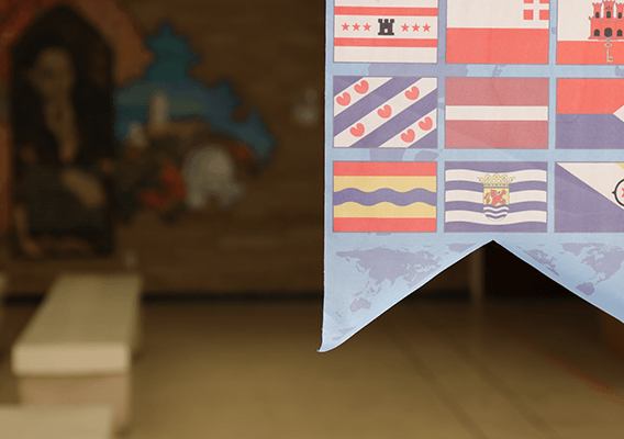 a banner hanging with multiple country flags on it