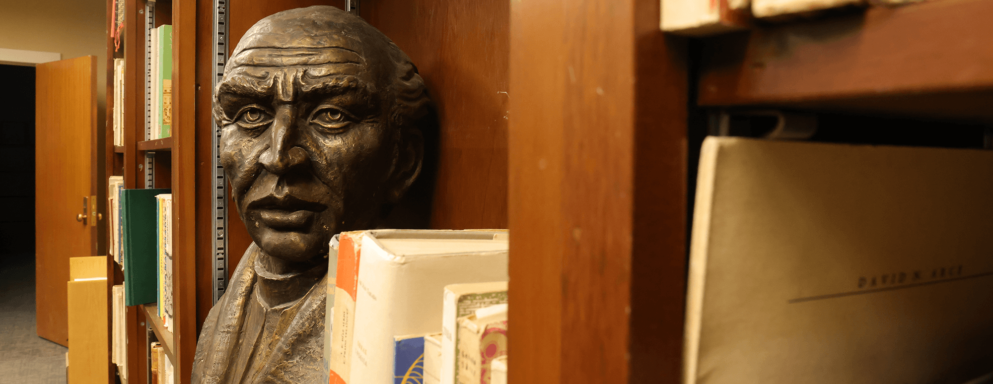 bust sitting on a bookshelf
