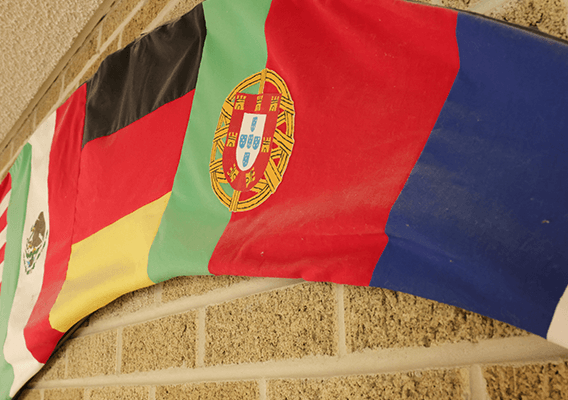 flags made into a banner posted on a brick wall