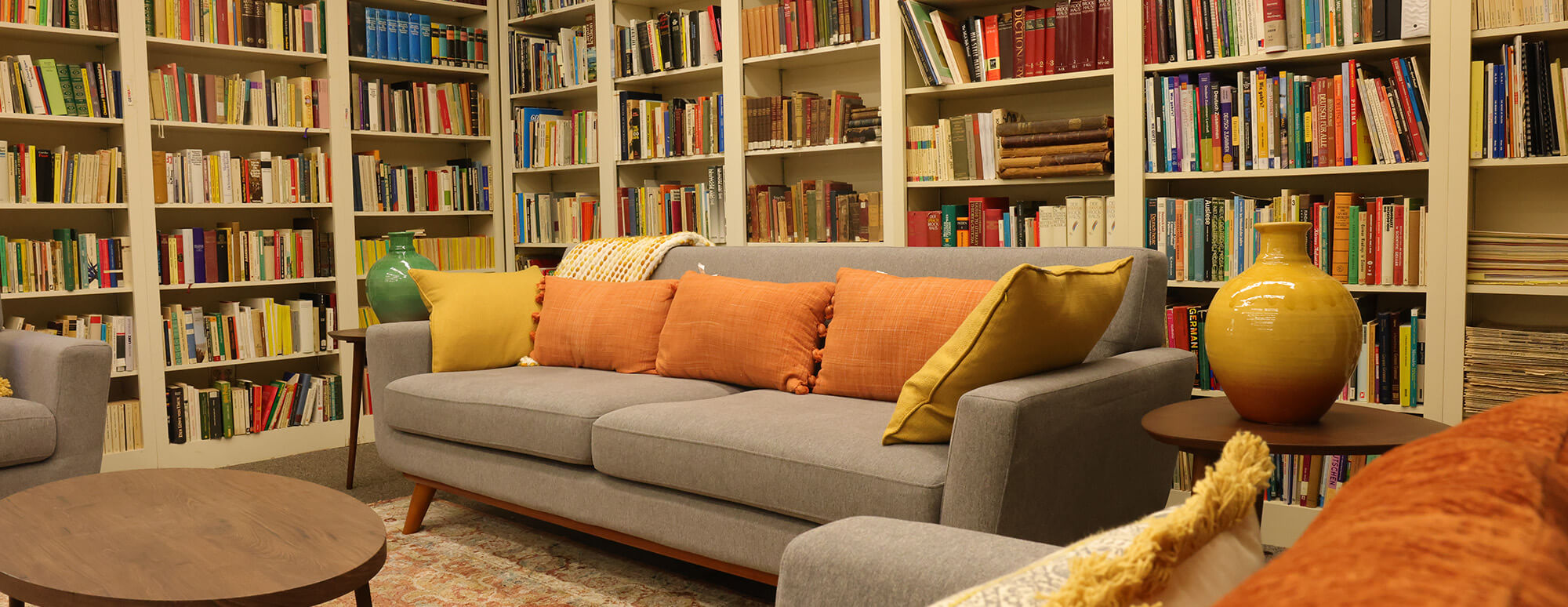 a modern century design room with bookshelf and a modern couch