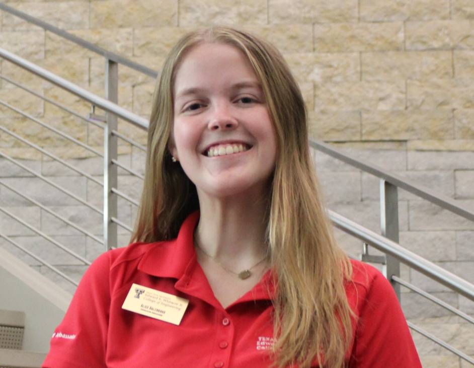 blonde woman with red polo on