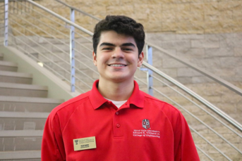 dark haired man in red polo