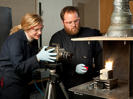 Dr. Michelle Pantoya and Billy Clark, a graduate student, demonstrate a reaction in the Texas Tech Combustion Laboratory.