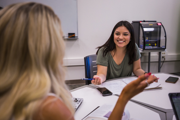 Students talking at a table