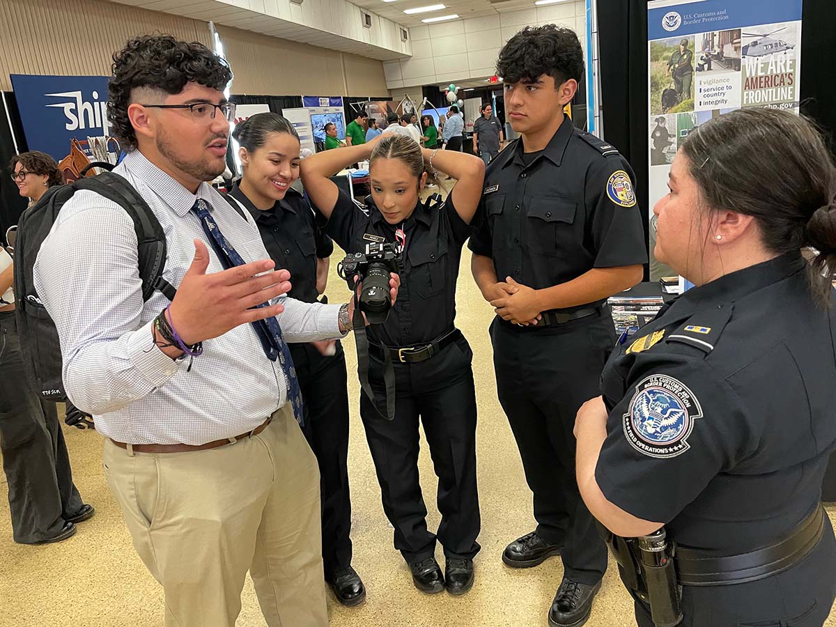 TTU student, Jacob Lujan speaking with U.S. Customs and Border Protection officials