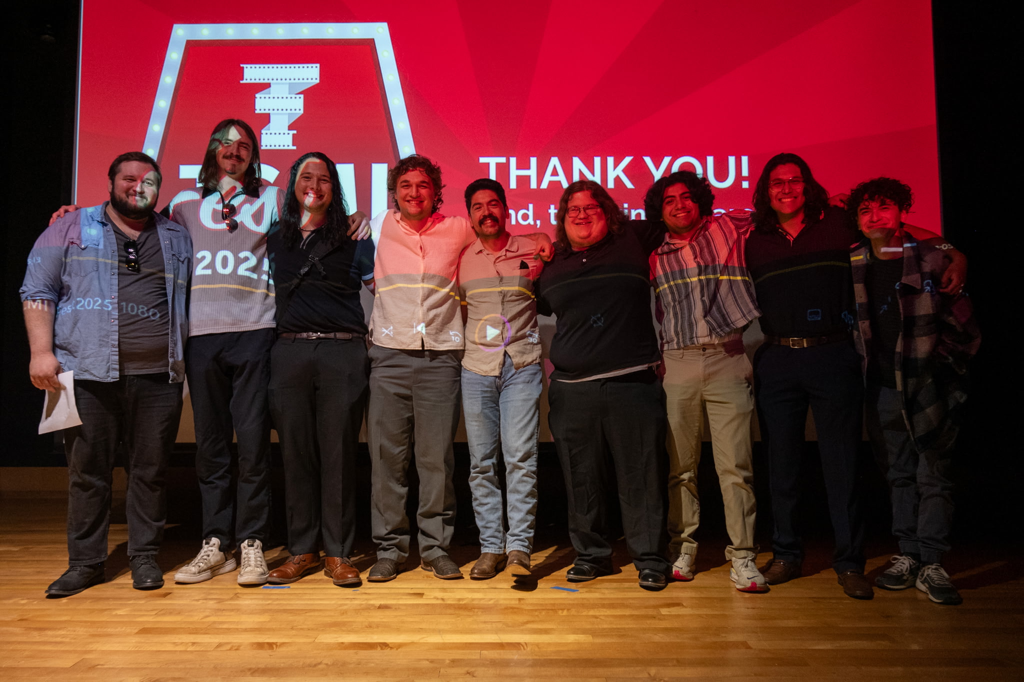 Students standing on stage together