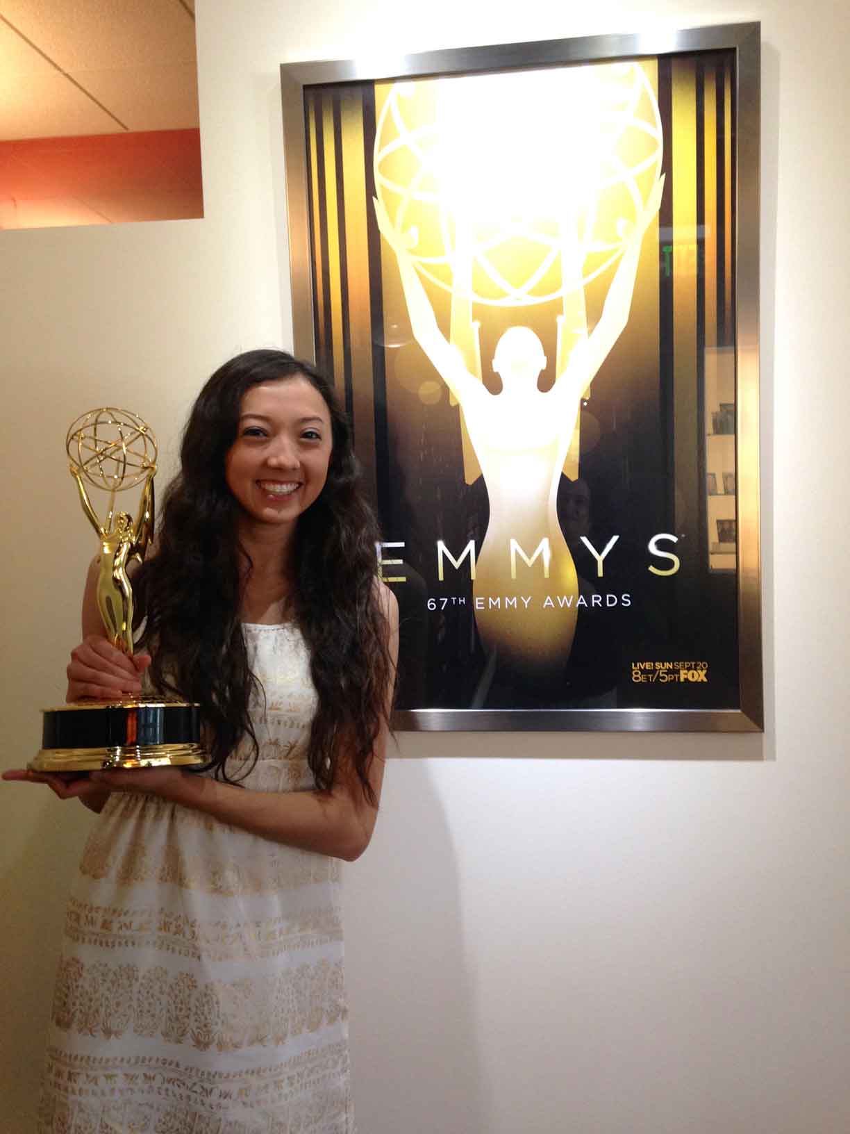 Jenabeth Morgan holding an Emmy