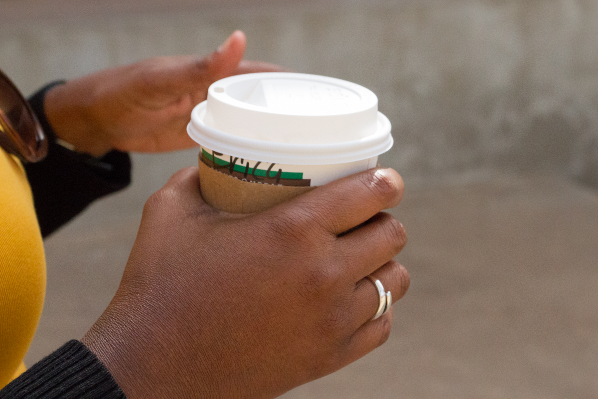 A coffee cup in Erica Taylor's hand