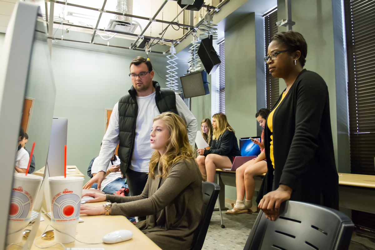 Erica Taylor and students looking at a production for the Double T Insider