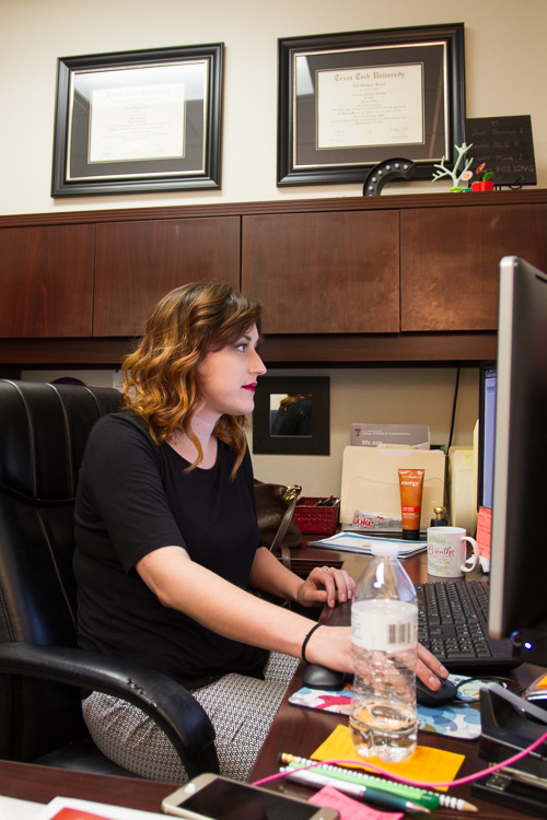 Cameron sitting at her desk