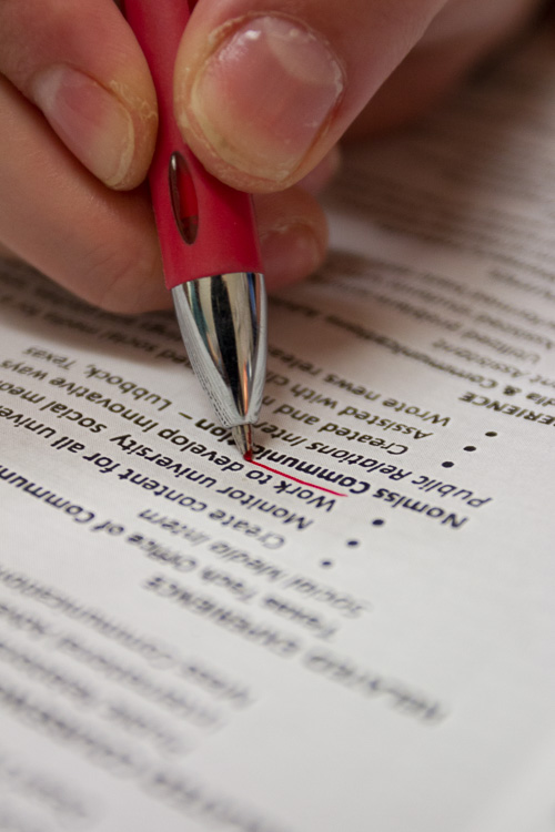 Red pen close up underlining a word