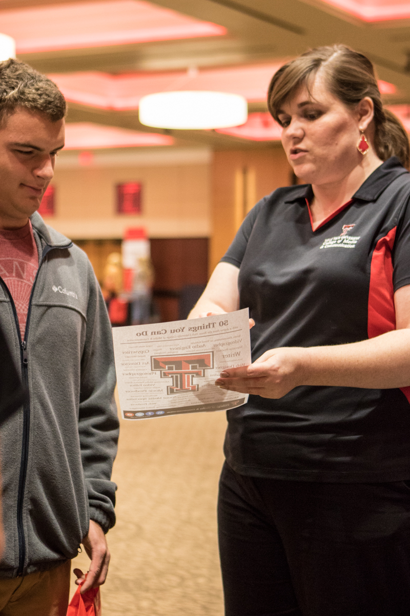 Emily talking to a high school student about our college