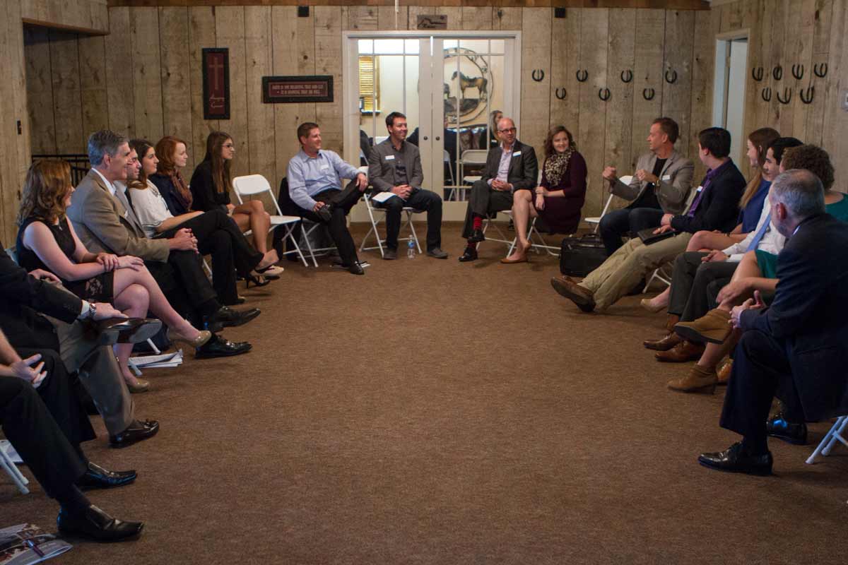 Students and mentors sitting in a large circle talking