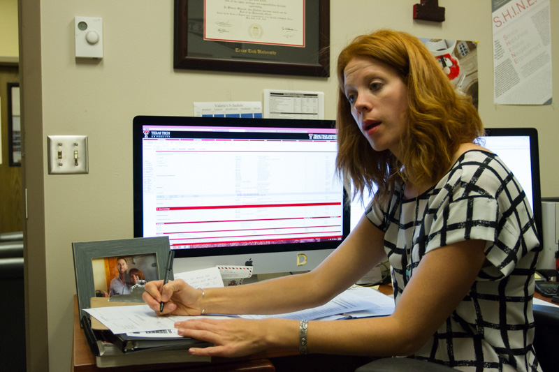 Debra sitting and talking with a student