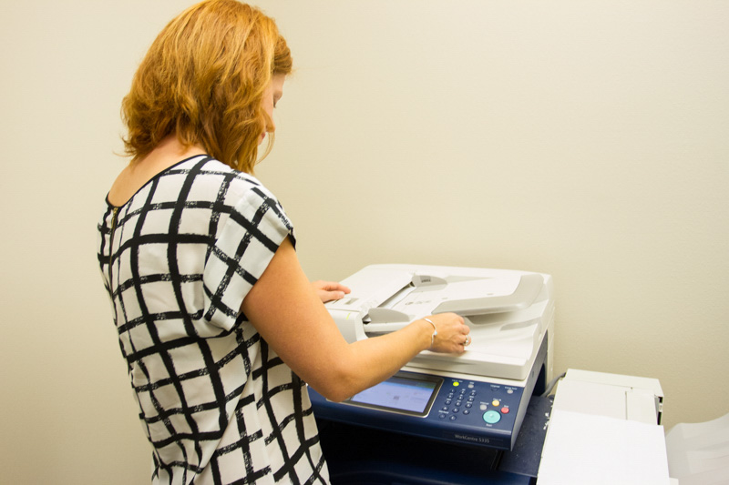 Debra making copies at a copy machine