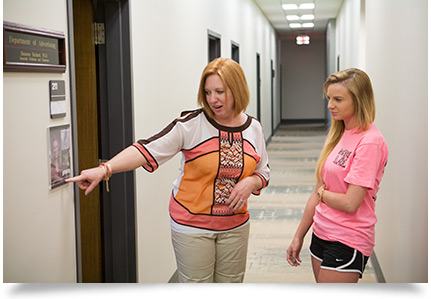 Advertising department chairperson Shannon Bichard, Ph.D., shares her photographs with Sami Hicks.