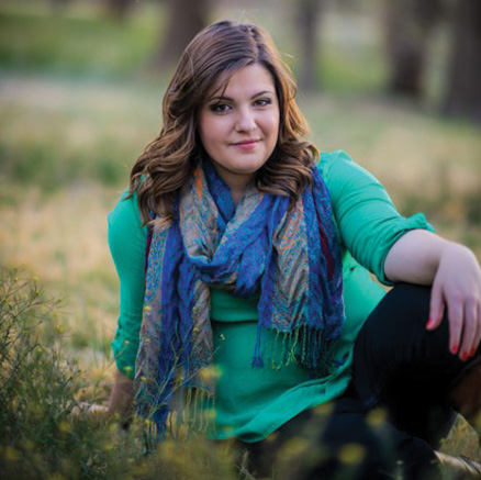 Sydney Holmes sitting in a field